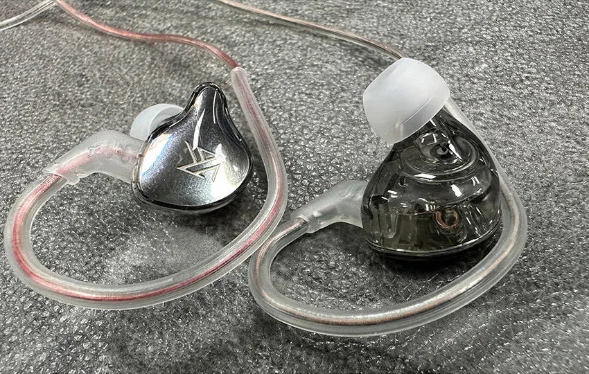 Two KZ EDCX earphones on gray background